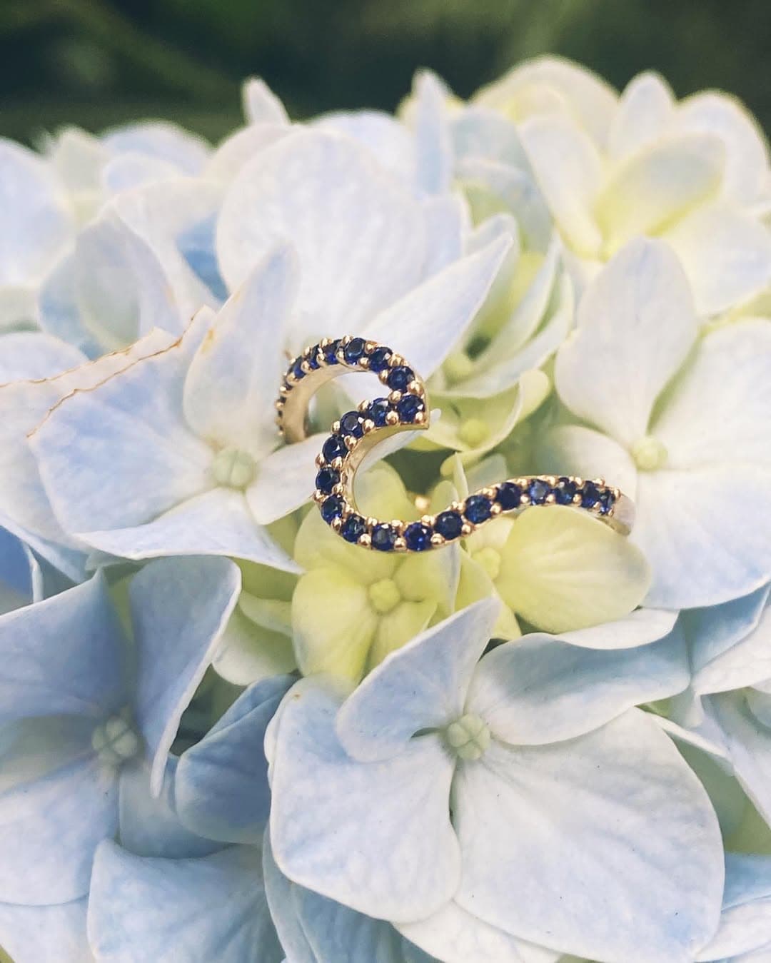 Woman wearing 8 number necklace with denim jacket